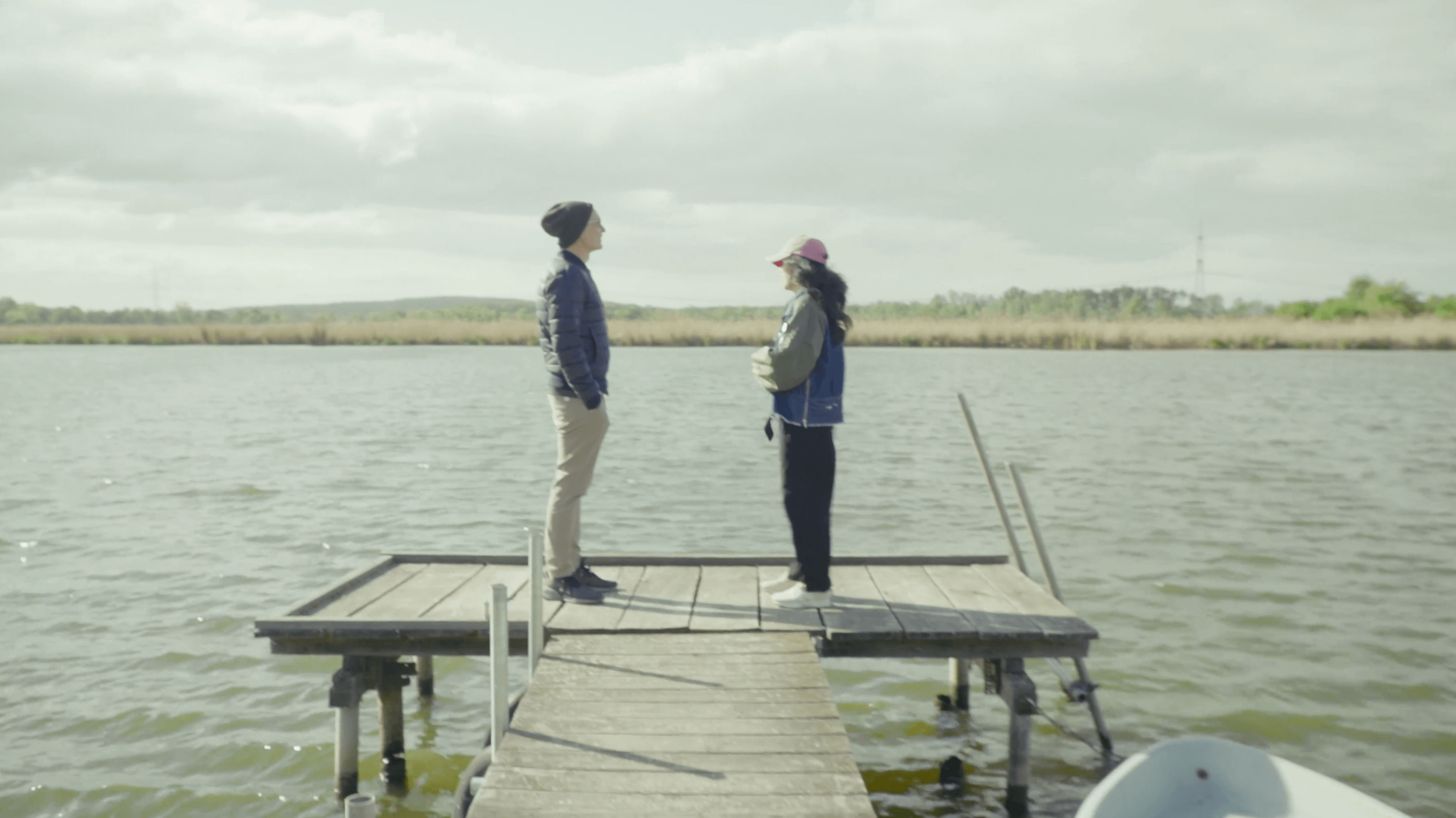 Matteo Cassese and a coaching client standing on a wooden dock by a lake