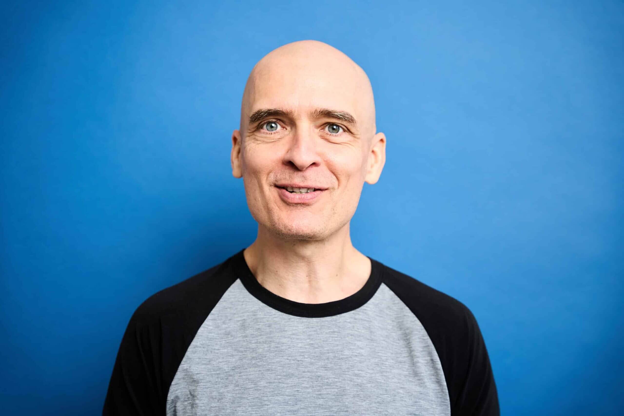 Portrait of Matteo Cassese with a smiling expression and a neutral background