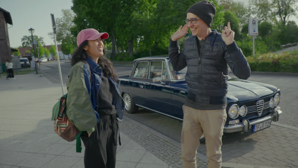 matteo cassese greeting a client by his vintage alfa romeo