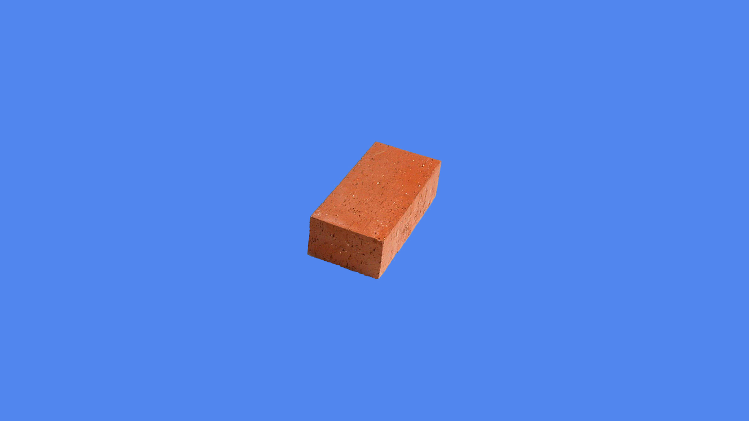 A small red clay brick, centered on a wide flat sky blue background