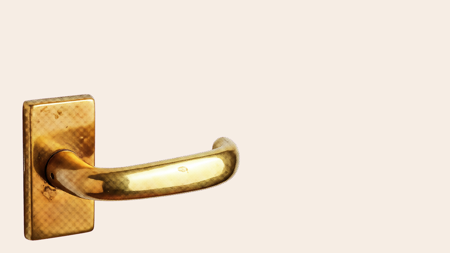 A brass door lever on a backplate, tarnished except for one patch polished by daily use, on a sand ground
